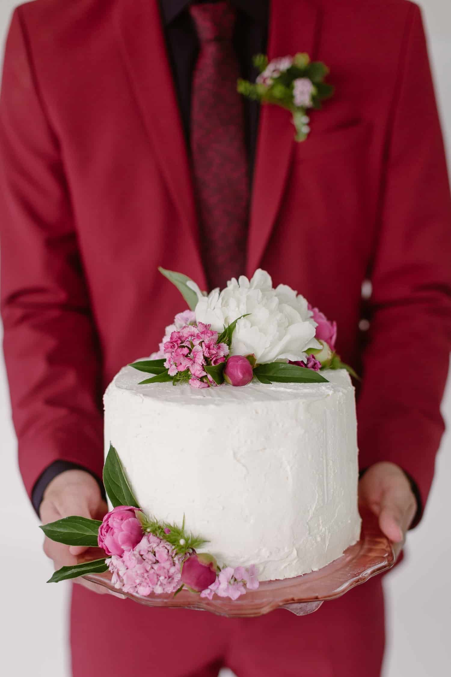 Groom holding wedding cake