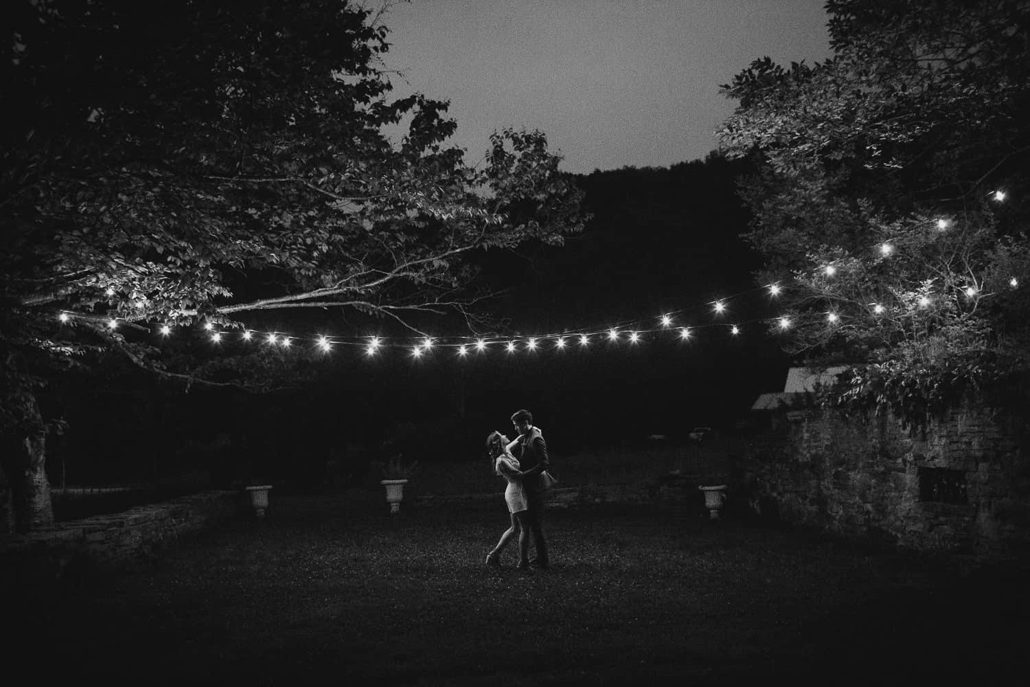 Wedding photos at night under string of light at Handsome Hollow 
