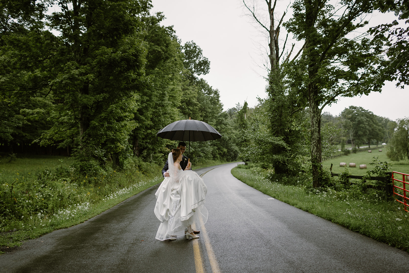 Rainy day wedding photos with umbrella 